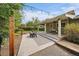 Spacious back patio is complete with outdoor seating, string lights, and privacy landscaping at 395 Zephyr St, Lakewood, CO 80226