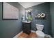Chic powder room with shiplap wall, modern vanity, and decorative accents at 395 Zephyr St, Lakewood, CO 80226