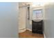Bathroom featuring tiled flooring, curved walk in shower, and a sink at 5719 S Lowell Blvd, Littleton, CO 80123