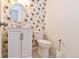 Stylish powder room features floral wallpaper, a modern vanity and oval mirror at 5719 S Lowell Blvd, Littleton, CO 80123