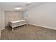 Bedroom boasts neutral carpet, a window and a vintage metal frame bed at 5719 S Lowell Blvd, Littleton, CO 80123
