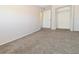 Spacious bedroom with neutral walls, carpet and closet with double-doors at 5719 S Lowell Blvd, Littleton, CO 80123