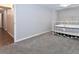 Cozy bedroom with neutral walls, soft carpet, and a stylish white iron bed frame at 5719 S Lowell Blvd, Littleton, CO 80123