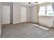 Spacious bedroom with neutral walls, plush carpet and large windows at 5719 S Lowell Blvd, Littleton, CO 80123