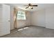 Bedroom features neutral paint, carpeted floors, large window, and ceiling fan at 5719 S Lowell Blvd, Littleton, CO 80123