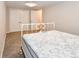 Comfortable bedroom featuring neutral walls, plush carpet, and a decorative iron bed frame at 5719 S Lowell Blvd, Littleton, CO 80123