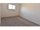 Empty bedroom with neutral carpet, light walls and natural light from the window at 5719 S Lowell Blvd, Littleton, CO 80123