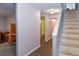 Hallway leads to a tiled bathroom and a carpeted room with desk and shelving at 5719 S Lowell Blvd, Littleton, CO 80123