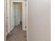 Hallway featuring neutral paint, plush carpet and white doors at 5719 S Lowell Blvd, Littleton, CO 80123