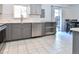 Well-lit kitchen boasts stainless steel appliances, tile floors, updated cabinets and plenty of counter space at 5719 S Lowell Blvd, Littleton, CO 80123