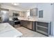 Modern kitchen with stainless steel appliances, gray cabinets, and granite countertops at 5719 S Lowell Blvd, Littleton, CO 80123