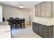 Kitchen and dining area with gray cabinetry, granite countertops, and open layout at 5719 S Lowell Blvd, Littleton, CO 80123