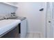 Laundry room features newer washer and dryer, white walls, and light tile floor at 5719 S Lowell Blvd, Littleton, CO 80123