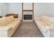 Cozy living area featuring sofas, a fireplace, and a classic piano for entertaining at 5719 S Lowell Blvd, Littleton, CO 80123