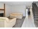 Open-concept living area featuring modern fireplace, neutral sofas, and staircase at 5719 S Lowell Blvd, Littleton, CO 80123