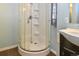 Corner shower features a clear glass door, shower head and built-in shelving at 5719 S Lowell Blvd, Littleton, CO 80123