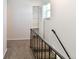 Carpeted staircase features black iron railing and a storage closet at 5719 S Lowell Blvd, Littleton, CO 80123