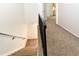 Carpeted staircase with black iron railing leads to the home's upper level at 5719 S Lowell Blvd, Littleton, CO 80123