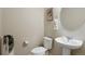 Elegant half-bathroom featuring a modern sink, toilet, and decorative touches for a refined aesthetic at 19593 W 93Rd Ln # E, Arvada, CO 80007