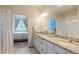 Bright bathroom showcasing double sinks, a granite countertop, and a separate shower for added convenience at 19593 W 93Rd Ln # E, Arvada, CO 80007