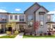 Stylish home exterior with gray siding, black trim, and manicured landscaping at 19593 W 93Rd Ln # E, Arvada, CO 80007