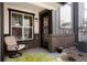 Inviting front porch with brick accents, seating, and decorative plants at 19593 W 93Rd Ln # E, Arvada, CO 80007