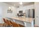 Contemporary kitchen with a large island, granite countertops, and stainless steel appliances at 19593 W 93Rd Ln # E, Arvada, CO 80007