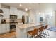 Modern kitchen featuring stainless steel appliances, granite countertops, and white cabinetry at 19593 W 93Rd Ln # E, Arvada, CO 80007