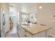 Bright kitchen with stainless steel appliances, granite counters, and an open layout leading to the living area at 19593 W 93Rd Ln # E, Arvada, CO 80007