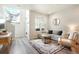 Comfortable living room with natural light, plush seating, and a decorative rug at 19593 W 93Rd Ln # E, Arvada, CO 80007