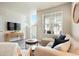 Cozy living room with a sectional sofa, natural light, and modern decor at 19593 W 93Rd Ln # E, Arvada, CO 80007