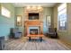 Cozy lounge featuring a stone fireplace, comfortable seating, and modern lighting for relaxation and comfort at 19593 W 93Rd Ln # E, Arvada, CO 80007