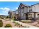 Charming street view of modern townhomes with well-maintained landscaping and walkways at 19593 W 93Rd Ln # E, Arvada, CO 80007