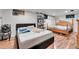 Basement bedroom with two beds and wood floors at 2990 Sheridan Blvd, Denver, CO 80214