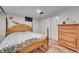 Basement bedroom with a queen bed and dresser at 2990 Sheridan Blvd, Denver, CO 80214