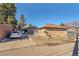 Brick home with driveway, fenced yard, and detached garage at 2990 Sheridan Blvd, Denver, CO 80214