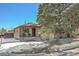 Brick ranch home with a covered porch, and snowy front yard at 2990 Sheridan Blvd, Denver, CO 80214