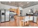 Updated kitchen with wood cabinets, granite counters, and island at 2990 Sheridan Blvd, Denver, CO 80214