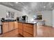 Bright kitchen with island, wood cabinets and wood floors at 2990 Sheridan Blvd, Denver, CO 80214