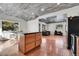Open concept kitchen with island and view into living room at 2990 Sheridan Blvd, Denver, CO 80214