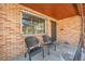 Small covered porch with two metal chairs at 2990 Sheridan Blvd, Denver, CO 80214
