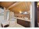 This bathroom offers a corner tub, a vanity with a vessel sink, a brick accent wall, and a wood ceiling with a skylight at 1203 24Th St, Denver, CO 80205