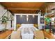 Well-lit bedroom featuring hardwood floors, an area rug, accent chairs and a platform bed with a bull skull above the headboard at 1203 24Th St, Denver, CO 80205