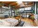 Spacious bedroom showing hardwood floors, an area rug, a platform bed, plants, stairs to loft and a sitting area with a massage chair at 1203 24Th St, Denver, CO 80205