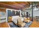 Bright bedroom featuring hardwood floors, an area rug, accent chairs and a platform bed with a bull skull above the headboard at 1203 24Th St, Denver, CO 80205