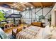 Spacious bedroom with wooden floors, exposed beams and an array of eclectic decor at 1203 24Th St, Denver, CO 80205