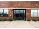 Modern building entrance with large glass doors and windows and brick facade at 1203 24Th St, Denver, CO 80205
