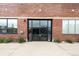 Building entrance featuring double glass doors, brick facade, and modern design at 1203 24Th St, Denver, CO 80205