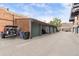 Exterior view of three garages with dark green doors and wood siding at 1203 24Th St, Denver, CO 80205