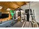 This lofted home gym with exposed wood beams includes free weights, machines, and plenty of natural light at 1203 24Th St, Denver, CO 80205